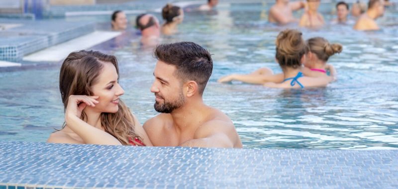 Fiatal pár fürdőzik a sárvári wellnessfürdő kültéri gyógyvizes medencéjében